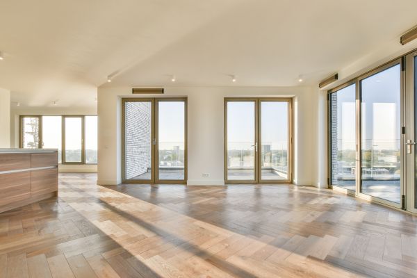 Windows, Doors & Siding Spacious, sunlit room with large windows showcasing modern window installation in Norwalk for enhanced views and energy efficiency.
